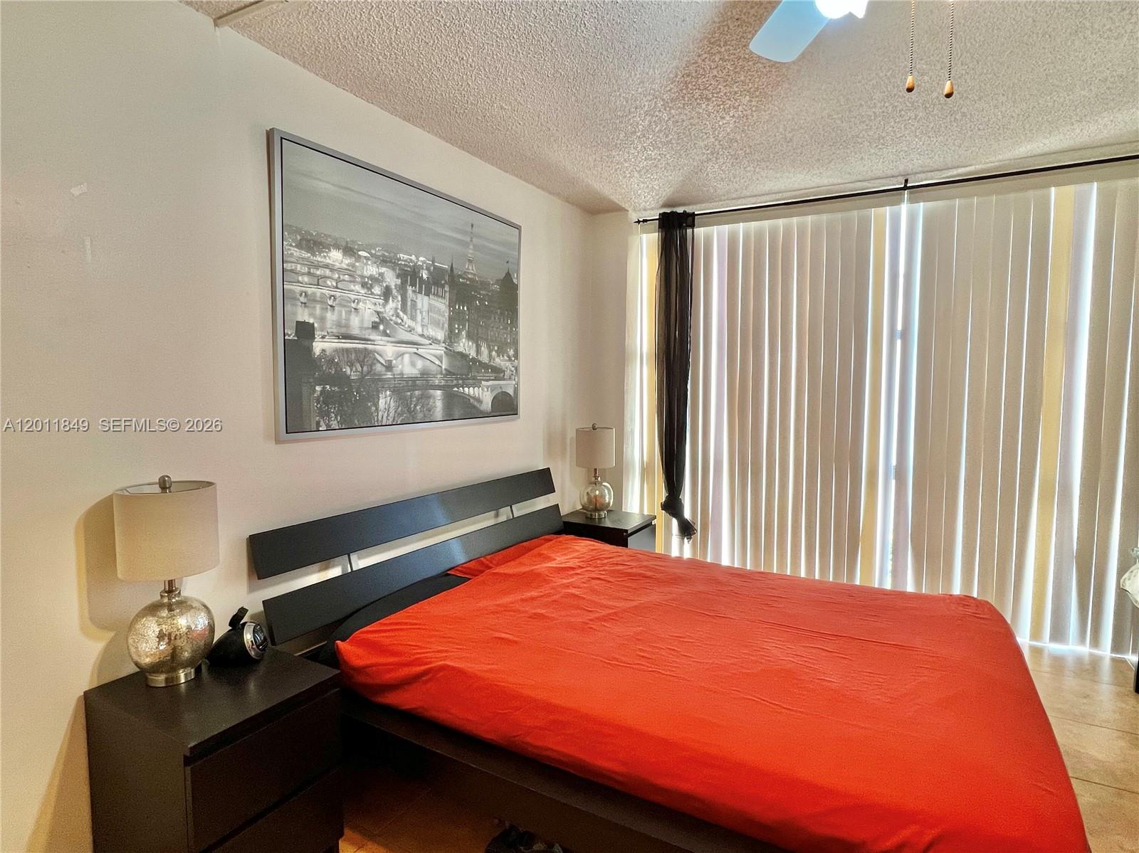 17011 North Bay Road, Unit 918 Sunny Isles Beach, FL 33160 - Photo 12 of 21 a bed sitting in a bedroom next to a window