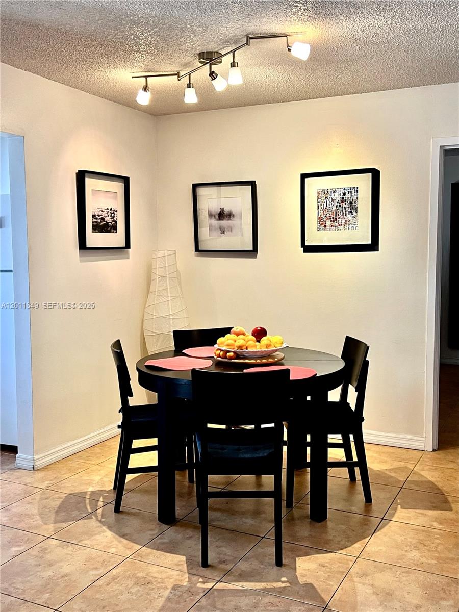 17011 North Bay Road, Unit 918 Sunny Isles Beach, FL 33160 - Photo 10 of 21 a view of a dining room with furniture