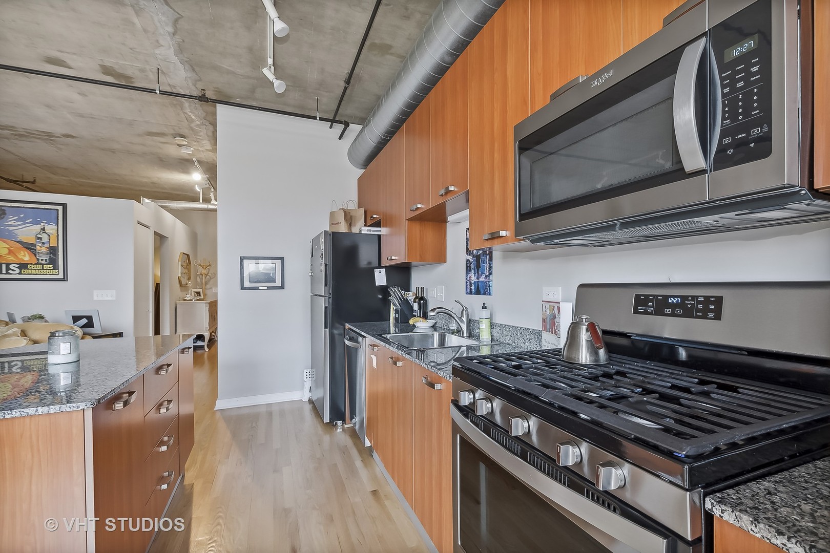 111 South Morgan Street, Unit 620 Chicago, IL 60607 - Photo 6 of 13 a kitchen with stainless steel appliances granite countertop a stove and a microwave