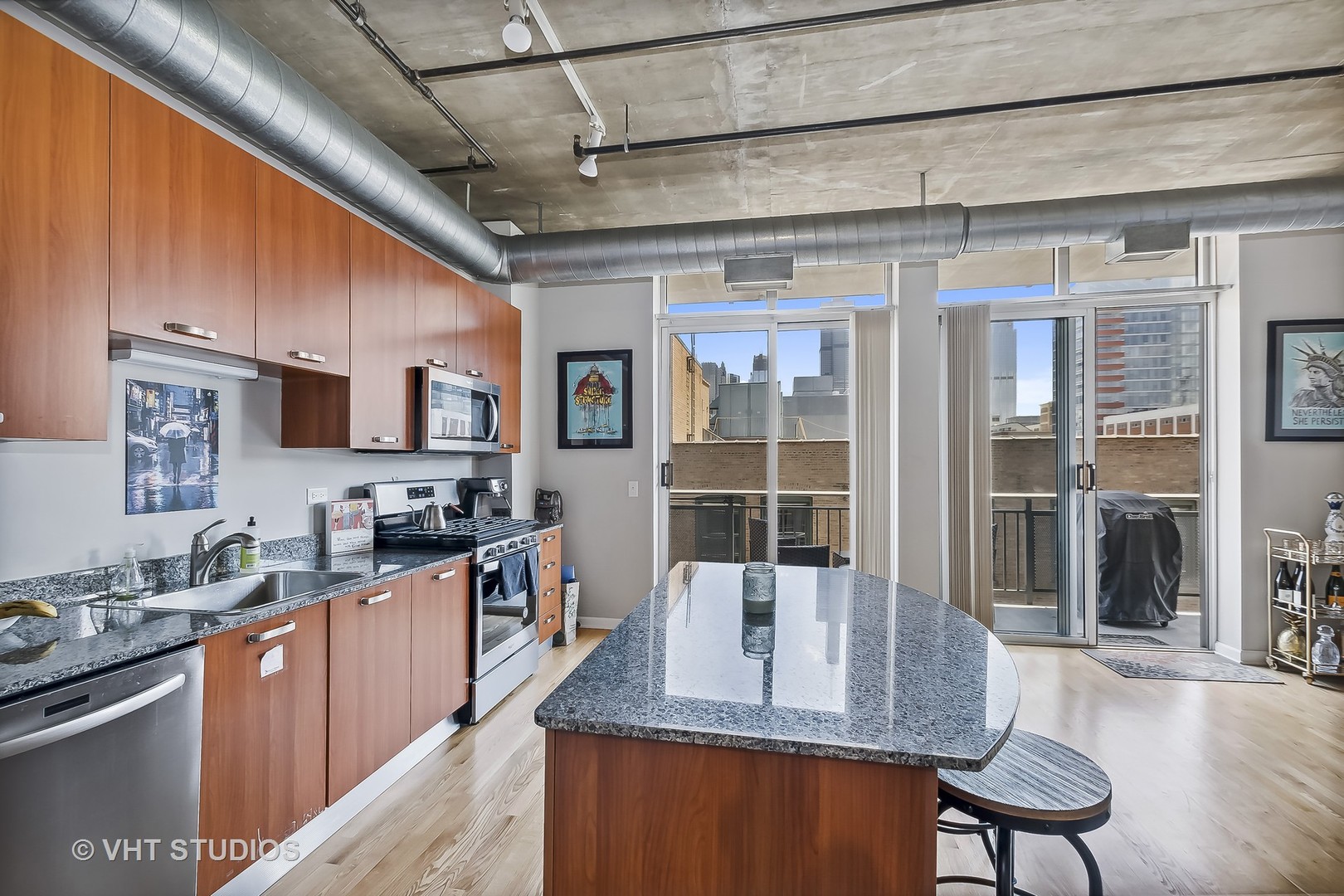 111 South Morgan Street, Unit 620 Chicago, IL 60607 - Photo 7 of 13 a kitchen with stainless steel appliances granite countertop a sink stove and refrigerator