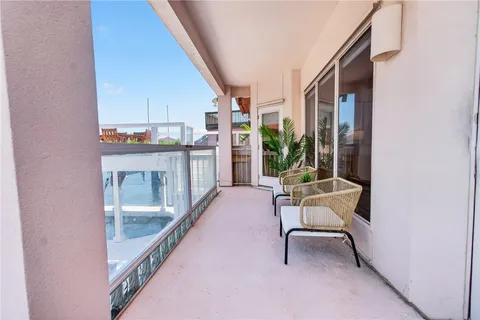 a balcony with furniture and a gate