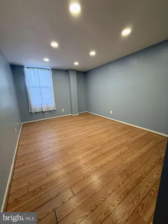 an empty room with wooden floor