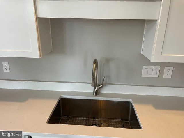 a stove top oven sitting inside of a kitchen