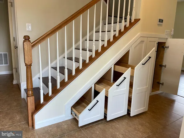 a view of staircase with lots of frames on wall
