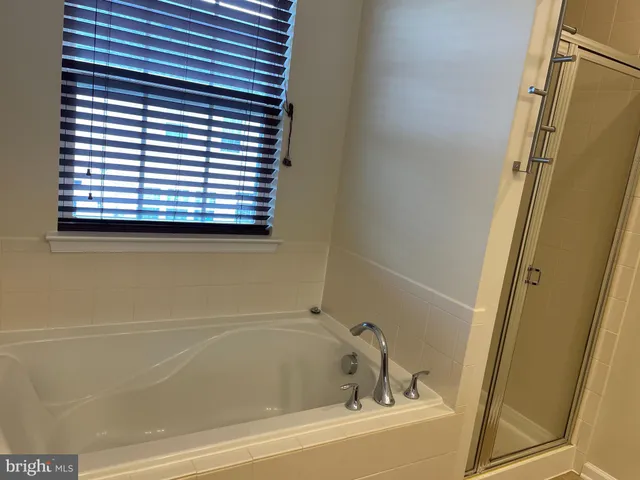 a bathroom with a bathtub and a window