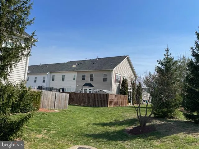 a view of a house with backyard and a garden