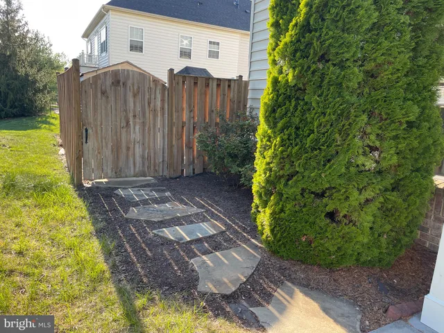 a view of a backyard with pathway