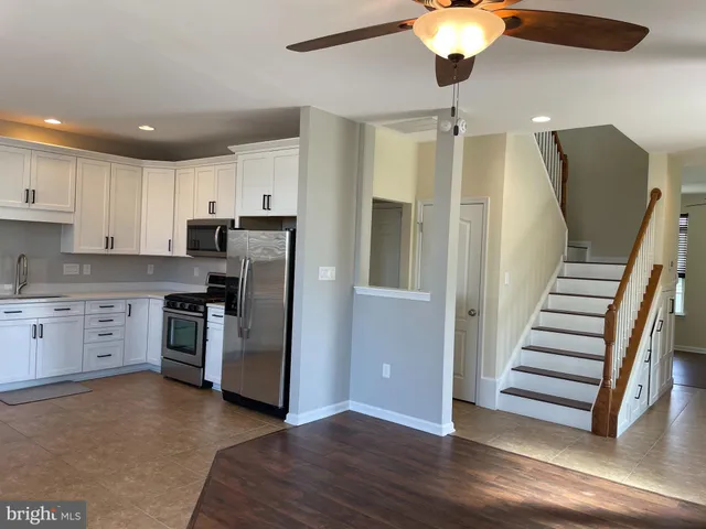 a view of an empty room with windows and a fireplace
