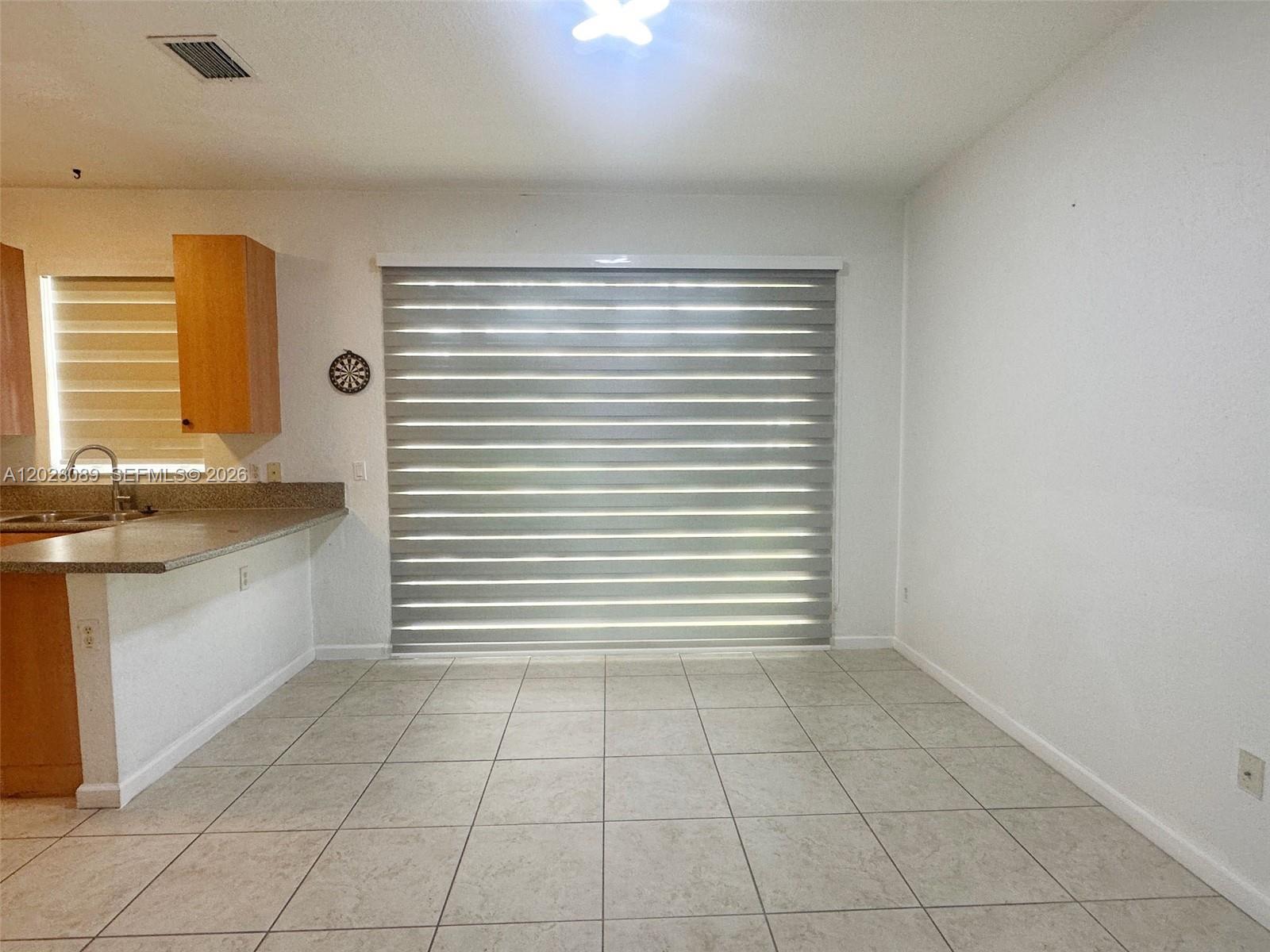662 Northeast 21st Terrace Homestead, FL 33033 - Photo 10 of 34 a view of an empty room with a window