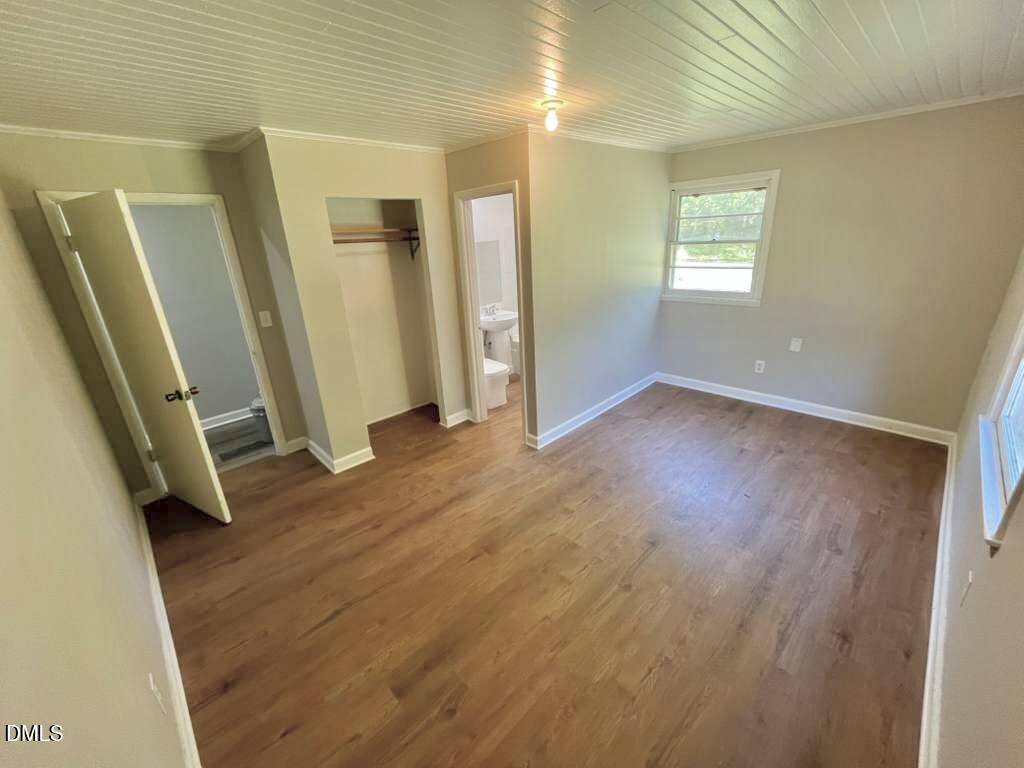 185 Summerhill Road Turkey, NC 28393 - Photo 12 of 18 a view of an empty room with wooden floor and a window