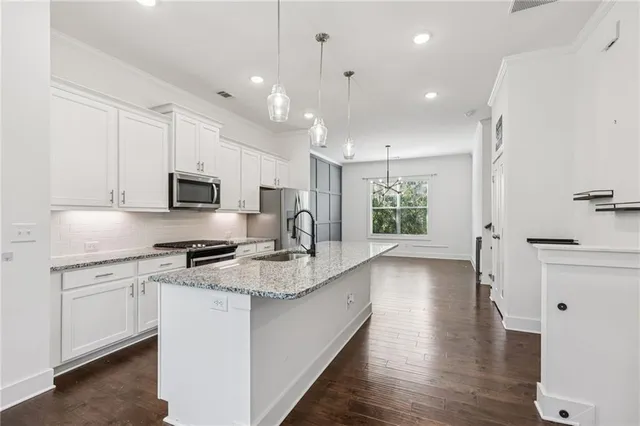 a kitchen with a sink stove and cabinets