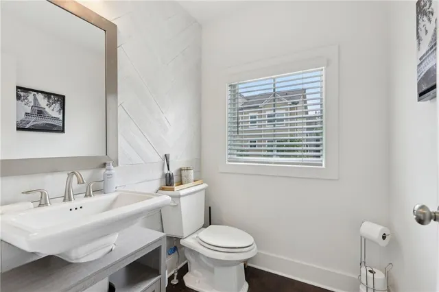 a bathroom with a toilet a sink and a window