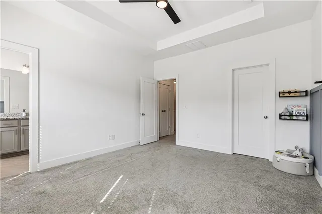 an empty room with cabinet and mirrors