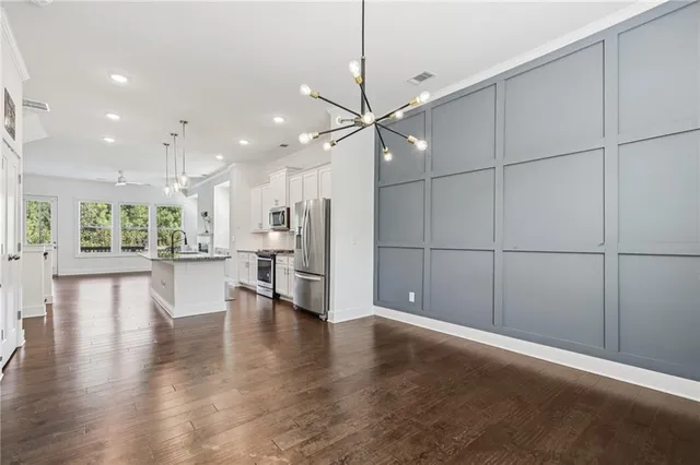 a view of a kitchen with a table and chairs