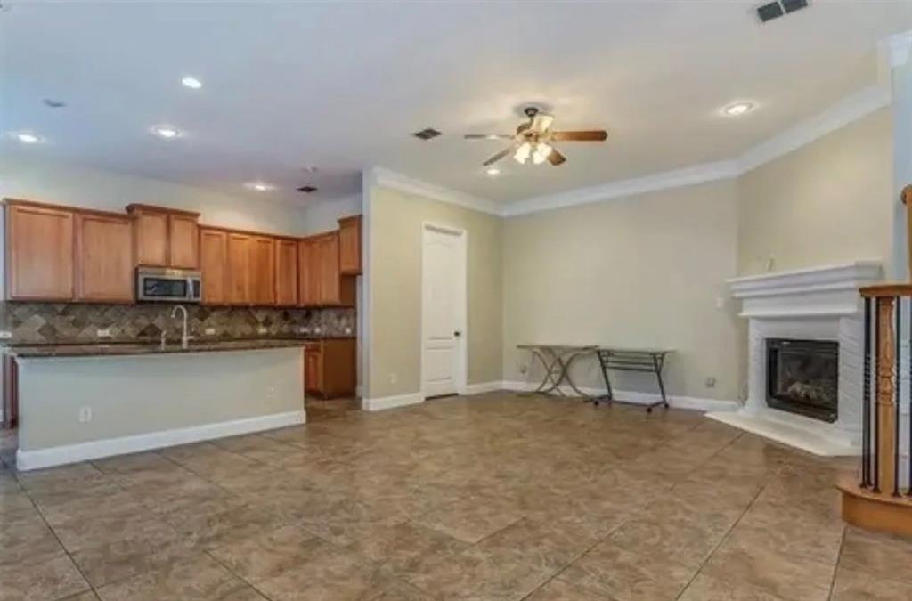228 Wallington Way Lewisville, TX 75067 - Photo 13 of 22 a view of a kitchen with a sink cabinets and a fireplace