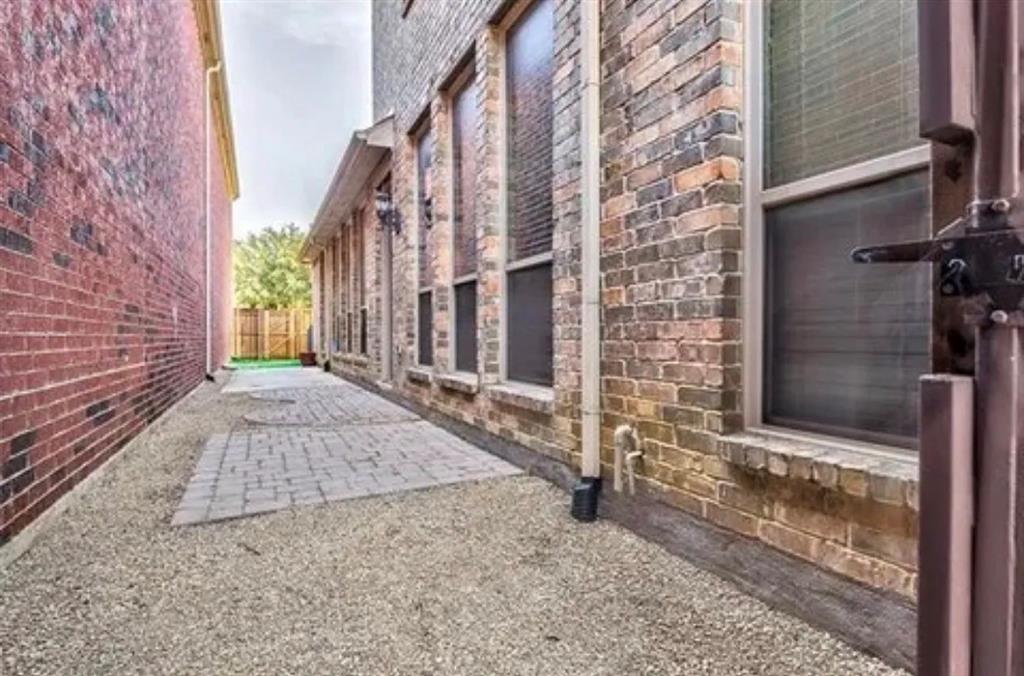 228 Wallington Way Lewisville, TX 75067 - Photo 15 of 22 a view of a brick house with brick walls