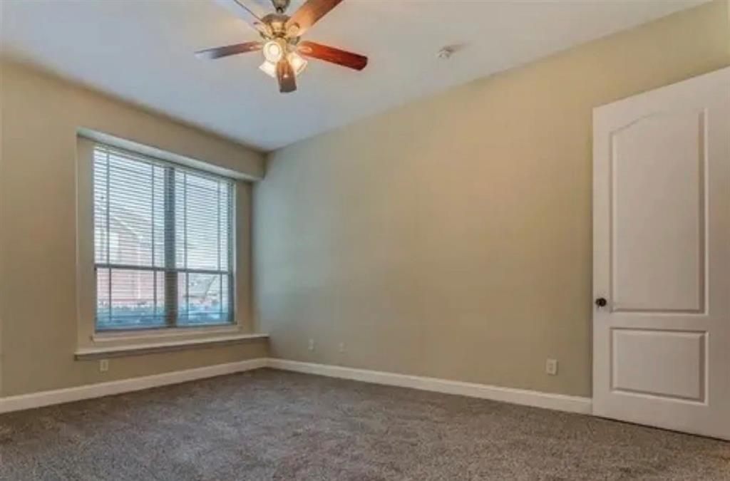 228 Wallington Way Lewisville, TX 75067 - Photo 19 of 22 an empty room with windows and fan