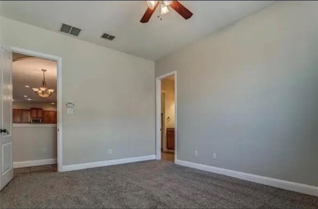 228 Wallington Way Lewisville, TX 75067 - Photo 22 of 22 an empty room with ceiling fan and window