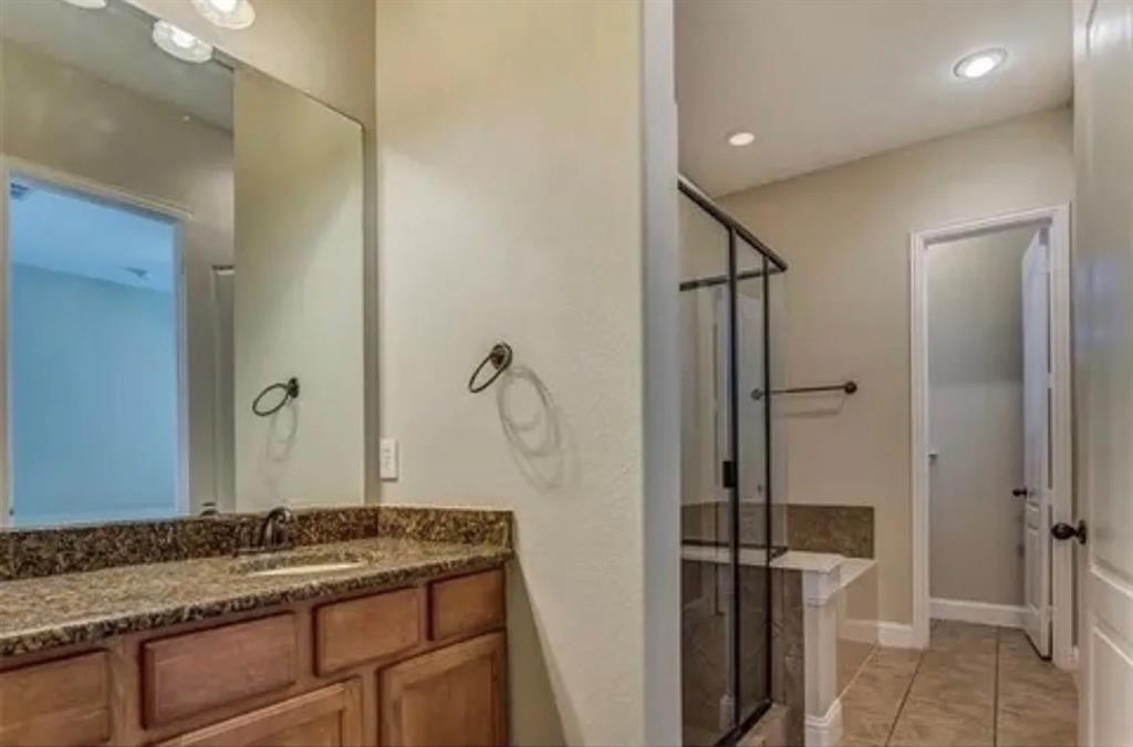 228 Wallington Way Lewisville, TX 75067 - Photo 5 of 22 a bathroom with a granite countertop sink a mirror and shower