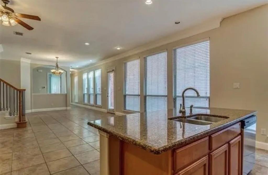228 Wallington Way Lewisville, TX 75067 - Photo 9 of 22 a kitchen with granite countertop a sink a counter top space and cabinets