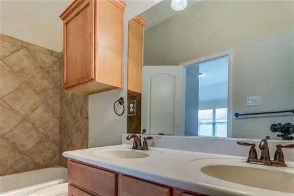 228 Wallington Way Lewisville, TX 75067 - Photo 10 of 22 a bathroom with a sink and a mirror