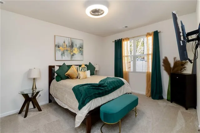 a bedroom with a bed and a chair