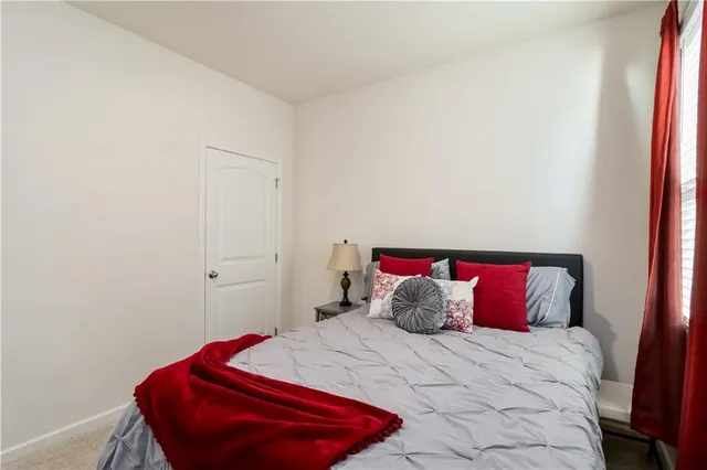 a bedroom with a bed and a chair