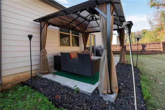 a view of a porch with furniture and a yard