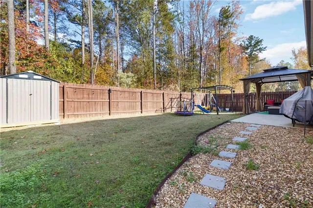 a view of a backyard with a garden and tree