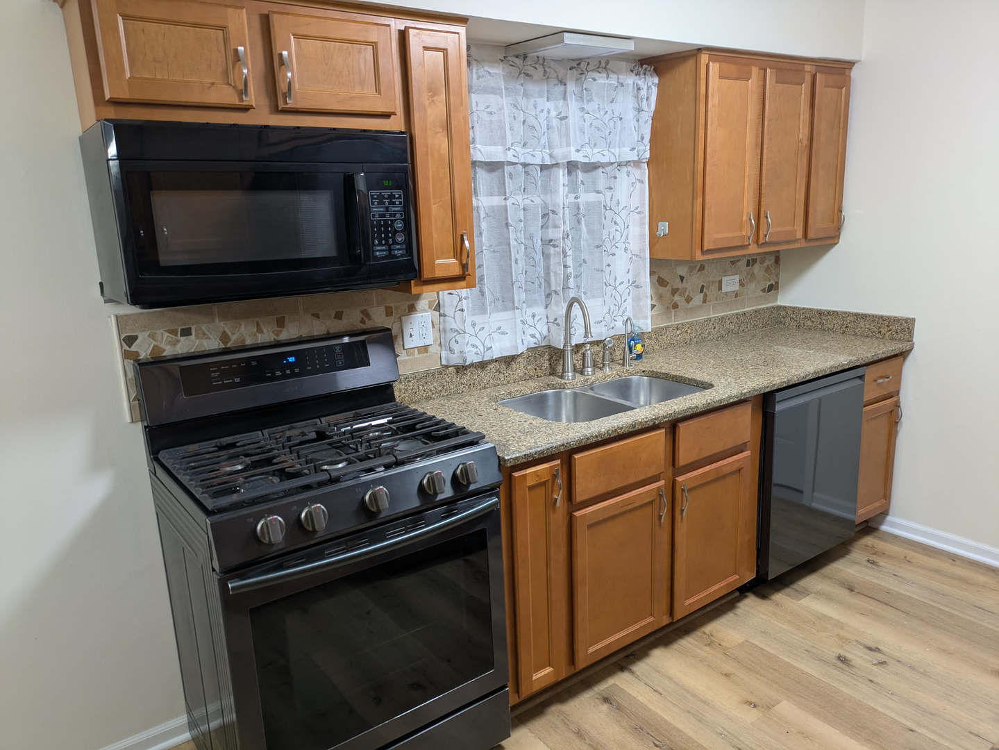 24031 South Cardinal Drive Channahon, IL 60410 - Photo 9 of 39 a kitchen with granite countertop a stove top oven microwave and cabinets