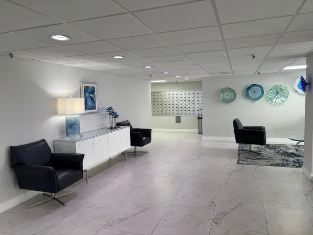 a living room with furniture and floor to ceiling window