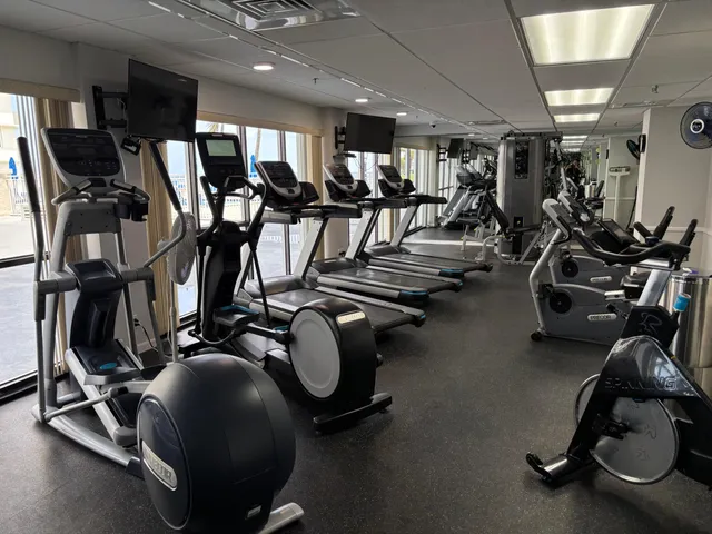 a room with gym equipment and a flat screen tv