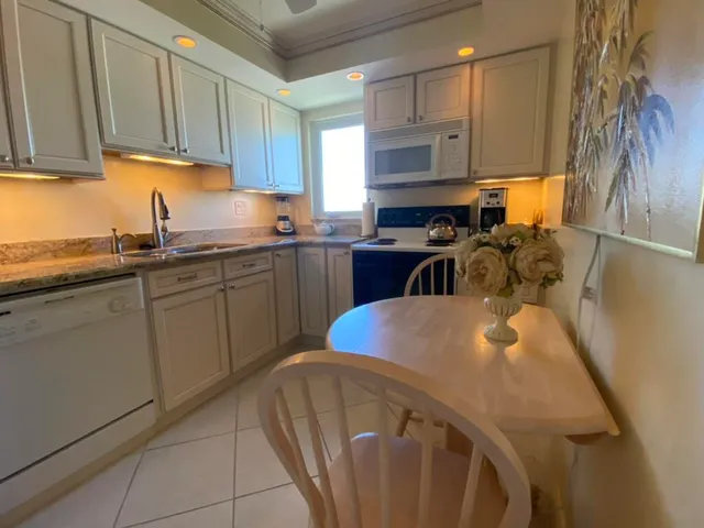 a kitchen with a stove and a wooden floor