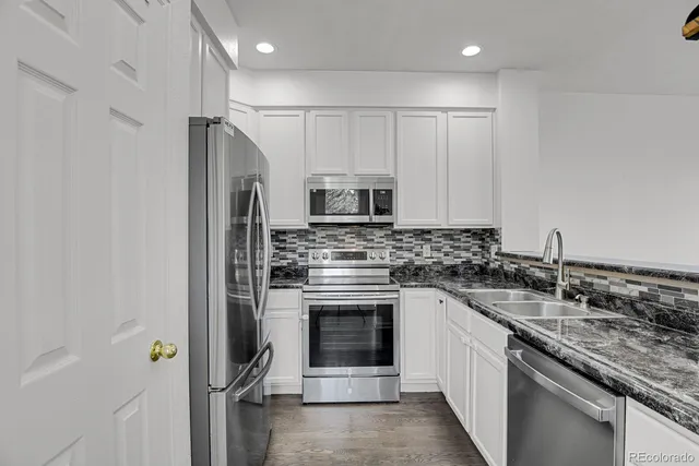 a kitchen with stainless steel appliances a refrigerator a stove a microwave and cabinets