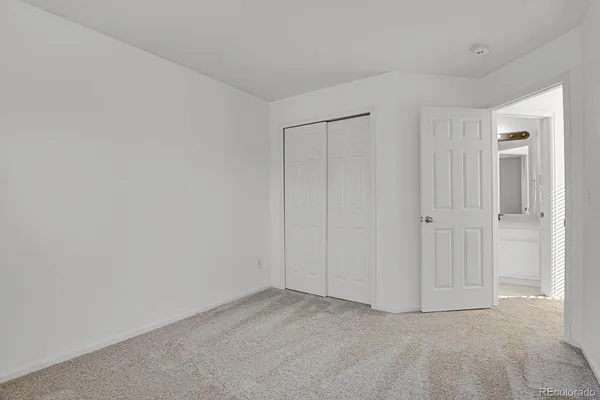 a bathroom with a sink a toilet and a large mirror