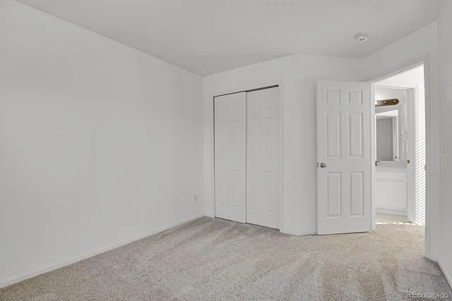 a bathroom with a sink a toilet and a large mirror