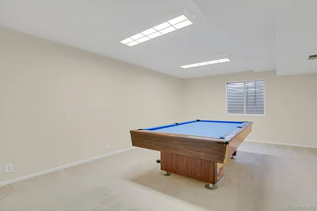 a room with pool table and a chandelier