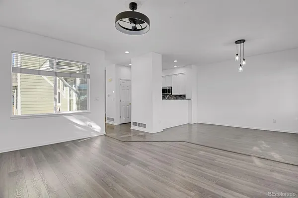 an empty room with a empty space and windows