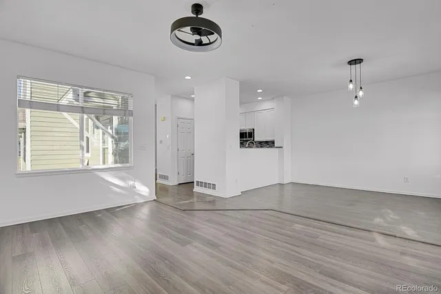 an empty room with a empty space and windows