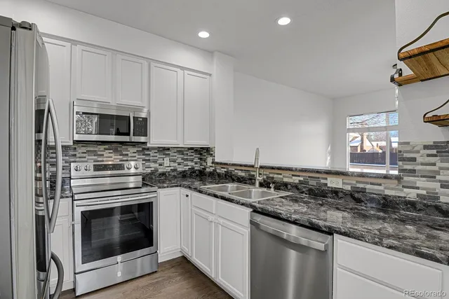 a kitchen with a sink stove and refrigerator
