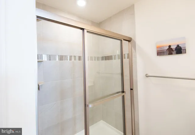 a bathroom with a shower and a glass door