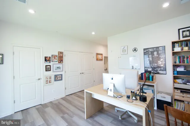 a living room with furniture and a book shelf