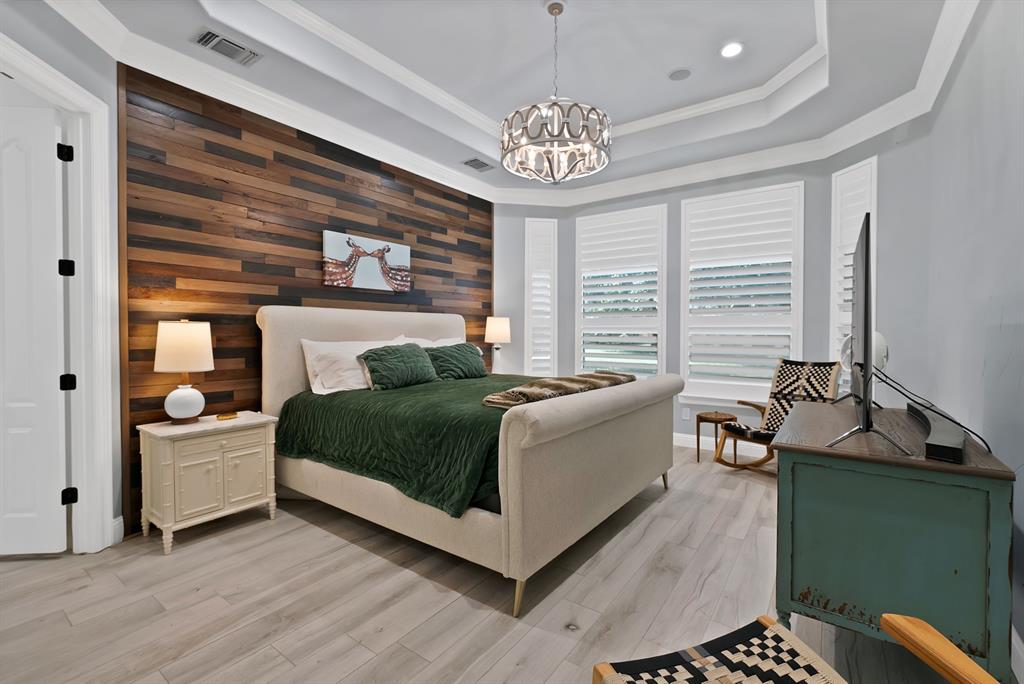 1501 Burleson Retta Road Burleson, TX 76028 - Photo 11 of 40 a spacious bedroom with a bed and a chandelier