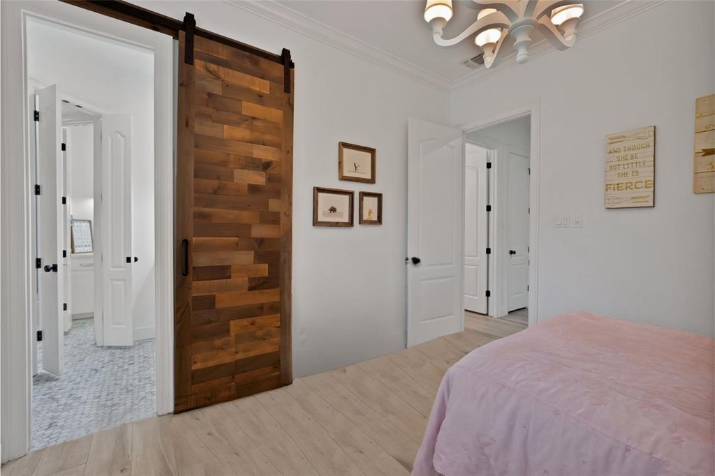 1501 Burleson Retta Road Burleson, TX 76028 - Photo 28 of 40 a bedroom with a bed and a chandelier