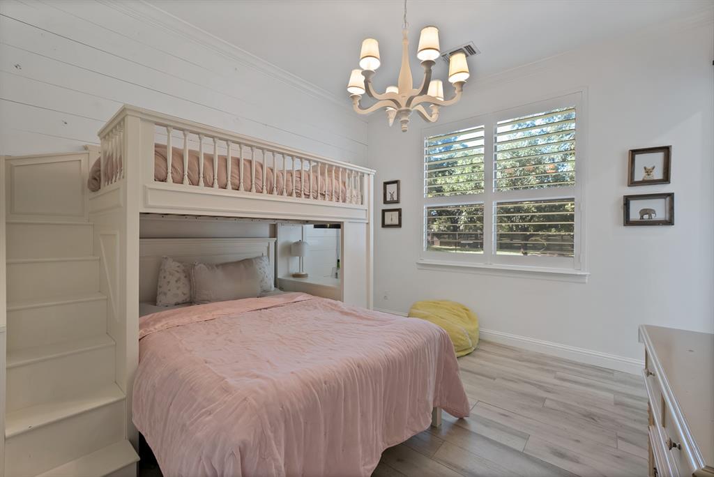 1501 Burleson Retta Road Burleson, TX 76028 - Photo 29 of 40 a bedroom with a bed and a chandelier