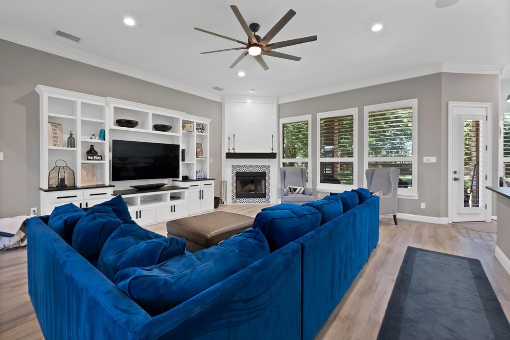 1501 Burleson Retta Road Burleson, TX 76028 - Photo 6 of 40 a living room with furniture a flat screen tv and a fireplace