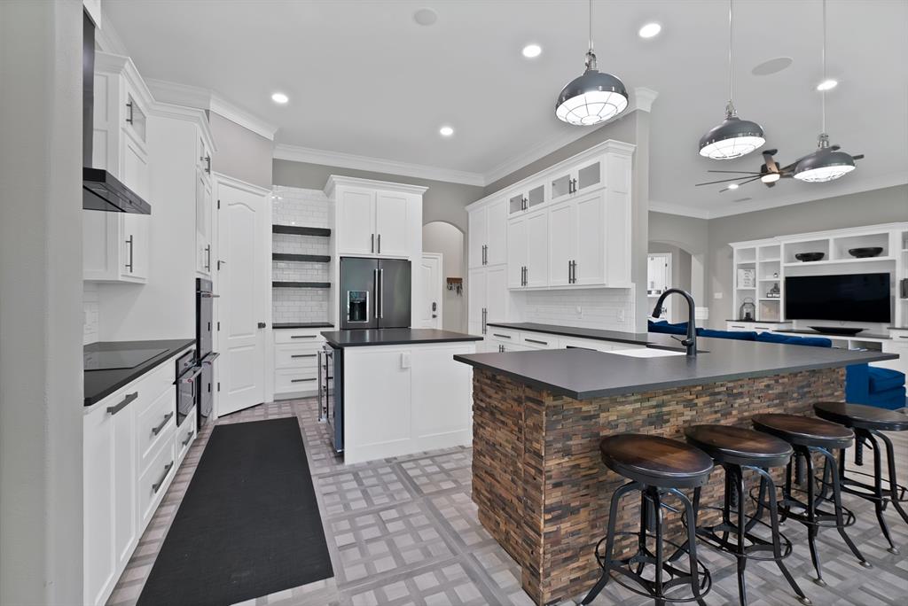 1501 Burleson Retta Road Burleson, TX 76028 - Photo 7 of 40 a kitchen with stainless steel appliances granite countertop a sink and a refrigerator