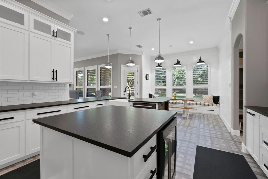 1501 Burleson Retta Road Burleson, TX 76028 - Photo 9 of 40 a large kitchen with kitchen island a stove a sink a counter space and a window