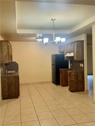 a kitchen with a cabinets and chandelier