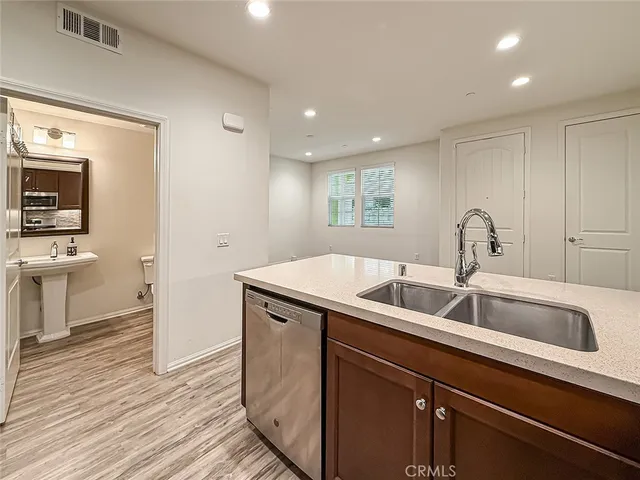 a kitchen with a sink and a refrigerator